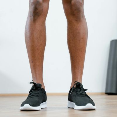 Close up on athletic shoes on a gym floor.